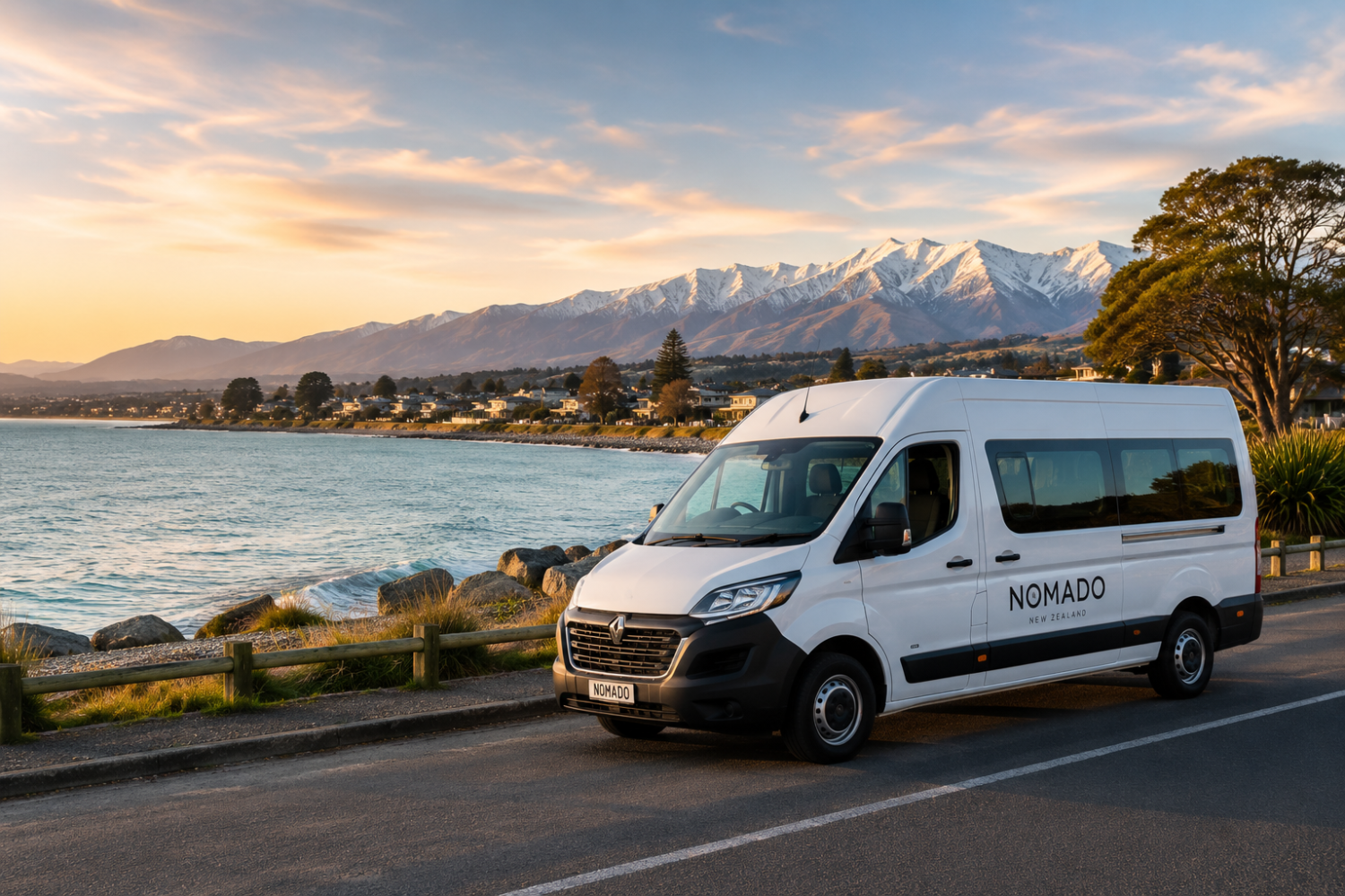 Nomado campervan parked near Christchurch coastline with Southern Alps in the background for campervan rental Christchurch and South Island road trips.